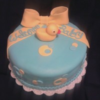 Welcome Baby Cake W/ Ducky 8inch round cake covered in fondant. Bow made w/ half gumpaste/fondant. Ducky made out of fondant. TFL