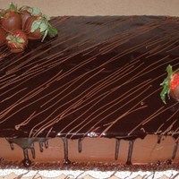 Chocolate Cake Chocolate cake with a strawberry filling and fudge sauce, topped with chocolate covered strawberries.