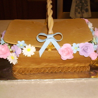 Kelly's Bridal Shower Cake for a bridal shower brunch. White cake covered in chocolate buttercream. Basket lid, handle and flowers are all gumpaste. This was my...