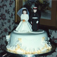 Marine & Bride 3 Tier Wedding Cake Fruit cake base covered with marzipan and sugarpaste. Sides done with peach and white double frill with peach bows and royal iced...