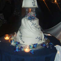One Of My Favorites This cake has pearl dust on the drapped fondant. It was beautiful without the navy vines as well. Used a rinestone buckle from the bead...
