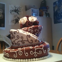 Topsy Turvy Wedding Cake With Fondant Rose Bouquet Topper This is a cake I finished today for a friend's wedding. The bottom tier is chocolate, the middle tier is rice krispie treat, and the...