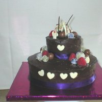 Frosted Fruits This was my first ever 2 tier cake decorated with Maltesers, frosted fruits, chocolate ribbons and chocolate hearts.