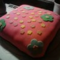 Flowers Spare of the moment birthday cake. Cake is covered in pink fondant with fondant cut outs.