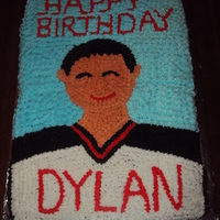 Birthday Cake Made to somewhat look like the birthday boy, in his hockey jersey. All out of buttercream.