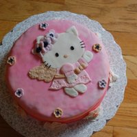 Hello Kitty Birthday Cake Birthday cake for my cousin. :D Made with MM fondant. The cake looks a little lumpy because I rolled the fondant to cover the cake too thin...