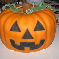 Pumpkin I made this for a halloween party, She wanted a real looking pumpkin, with a face on it.. and vines ...I used fondant for everything, gum-...