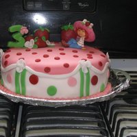 Strawberry Shortcake This was for a 3yr olds b-day All the flowers, and strawberrys are hand made. she showed me 2 pictures of cakes she wanted... so I put them...
