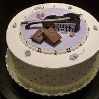 Violin And Violet Birthday cake for a violinist who loves violet. Buttercream cake. Decorations on top all in sugarpaste and royal icing.