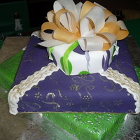 Stacked Presents 3 stacked present cakes, covered in fondant with fondant accents and topped with an airbrushed rice paper bow!