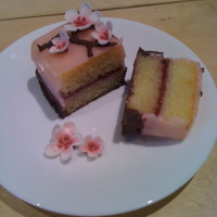 Cherry Blossom Petit Four Cake with sugarpaste flowers and chocolate piping.