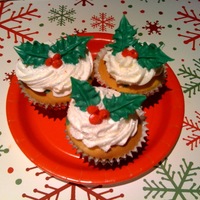 Holly Cupcakes Frosted with buttercream. Holly is made from chocolate.
