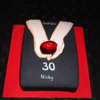 Twilight Cake Oblong spong with black icing on a red iced board. I cut out the arms in flesh coloured icing and shaded them before painting the apple and...