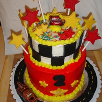 Lightning Mcqueen 1st attempt at a tiered child's bday cakeVanilla Cake with Reduced Fat Vanilla Buttercream and Vanilla Suckers