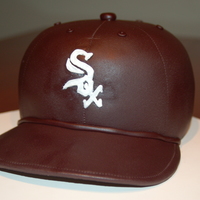 Chicago White Sox Birthday Cake FOndant covered birthday cake sculpted in the shape of a white sox baseball hat.