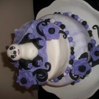 Pandar-Ifac Birthday cake for my niece. Light violet and black flowers. Panda is sitting on a blanket on top. My first panda...Tried new recipe orange...