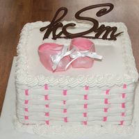 Pink Booties White cake with fondant booties. Chocolate monogram intials.