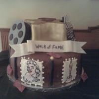 Hollywood Cake Bottom layer is chocolate with raspberry filling, star shaped cake is red velvet cake with cream cheese filling. Both tiers and covered in...