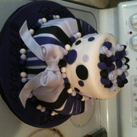 50Th Birthday Cake My first attempt at a tiered cake. The cake is covered in fondant, the dots and stripes are fondant, and the bow is fondant/gum paste mix....