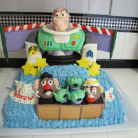 Buzz Lightyear Cake 1/2 sheet cake. Buttercream frosting. Buzz is cereal treats covered in modeling chocolate. All other characters are solid modeling...