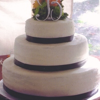Brown Ribbon Wedding Cake This was a wedding cake for my cousin's wedding. The top and bottom layers have pearl dragees on them. Brown double sided satin ribbon...