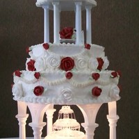 Traditional Wedding Cake. White cake iced in buttercream, decorated with red and white, royal icing roses.