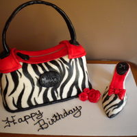 Purse And Shoe Cake This cake is cover in fondant and hand painted. This was the first time I have ever did a shoe. I think it turned out nicely. My customer...