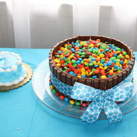 M&m Cake I did this cake for my son's birthday. It was a huge hit. It was 2, 9 in. rounds covered in buttercream. Lined with KitKats and topped...