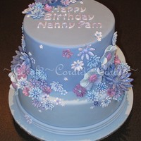 Very Violet White Chocolate mud cake with Baileys & white chocolate ganache & fondant. Flowers were made out of a mixture of mexican paste and...