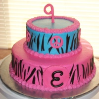 Zebra Strip And Peace Signs 2 Tier birthday cake iced in BC with MMF zebra stripes and Peace signs