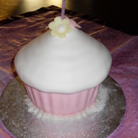 Giant Cup Cake madeira sponge with strawberry butter cream in cored out sections in cake covered in fondant.