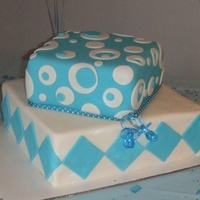 Baby Boy My first cake ever. MMF over buttercream. Yellow cake on bottom, chocolate on top.