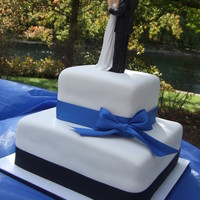 Simple Wedding My first wedding cake. Marble cake and buttercream icing/filling under MMF. Bride wanted the black and blue ribbon...not my first choice in...