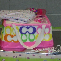 Coach Baby Bag 3 1/4 sheets stacked and carved..butter cream with fondant accentsActual baby items