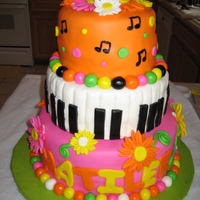 Piano/daisy Cake This is my 2nd fondant cake. It was for my pastor's daughter. She said she wanted piano keys and daisies, and her fave colors are pink...