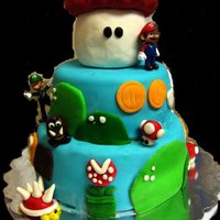 D's Birthday Cake Chocolate cake with fondant & fondant accents. Mario & Luigi were toys that the birthday boy got to keep. This was my first cake...