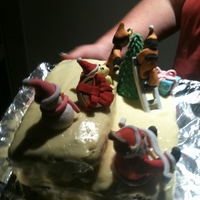 First Xmas Cake the figures are made out of royalty soft white icing. the cake was a carrot cake with lemon icing