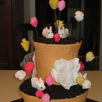 Flower Pot Easter Cake Pound cake with buttercream covered in Fondant with crushed cookies for soil. Flowers are Fondant. Bunnies are gumpaste. Thanks for looking...