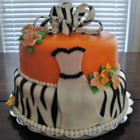Zebra Stripe & Orange Cake covered with fondant, fondant zebra stripes on bottom layer, fondant and buttercream formal gown, gumpaste flowers and topped with...