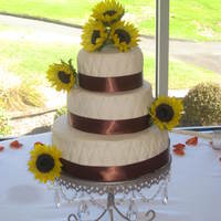 Quitled Wedding Cake Chocolate cake with BC filling and covered in fondant. Quilted detail with edible pearls. Satin ribbon around base. 3 cakes per tier. Fresh...