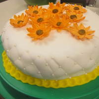 Fondant Class Final Cake Chocolate cake covered in wilton fondant with stitching technique on the side and pearl dragees. On top are gumpaste "sunflowers&quot...