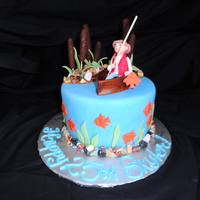 Gone Fishing! 8" round vanilla cake with almond buttercream filling. Covered and decorated in fondant. Rocks are chocolate candies.