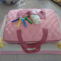 Diaper Bag This is a strawberry cake, with strawberry perserve filling and strawberry cream cheese frosting covered in fondant.
