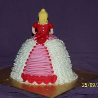 100_3918.jpg this was my daughters bday cake it was a dolly varden tin choc mud with butter cream icing asell covered in RTR icing and all decorations...