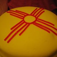 New Mexico Birthday Cake The flag of the state of New Mexico... as a birthday cake. 3 layers of chocolate + chocolate icing, with yellow fondant cover and red...