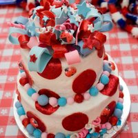 Ladybug/4Th Of July Cake Cake is covered in Buttercream Icing with Fondant decorations and a fondant bow topper.