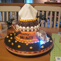 Halloween With Strobe And Blinking Lights. My first two tier cake. I had two blicking lights behind the coffen and a strobe light under the ghoust that showed through the gumpaste....
