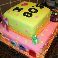 80'd Themed Birthday Cake 80's themed birthday cake. All accents are hand made out of fondant, modeling chocolate and rice krispie treats