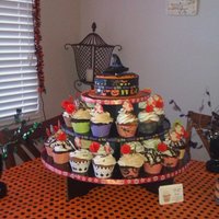 Halloween Cuppies And Cake halloween cupcakes, in 6 different flavors and choc mud cake covered in fondant, ribbon and witch hat cookie.