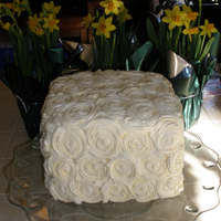 Rose Cake With Rainbow Layers Yellow cake rainbow colored layers with rose shaped butter cream frosting